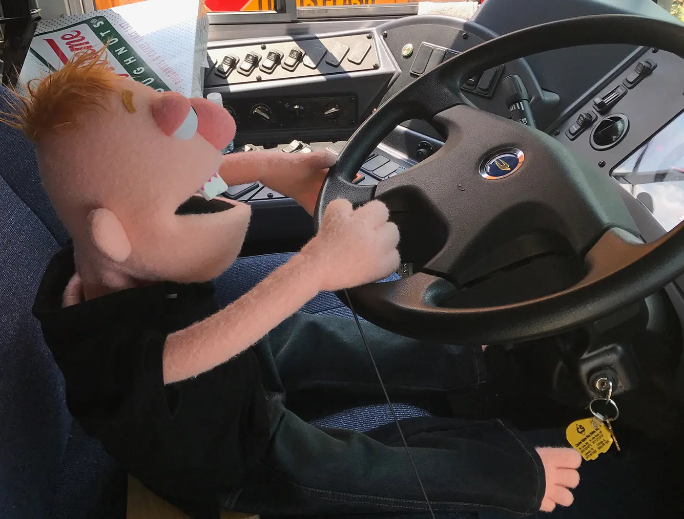 Lil’ Trent at the wheel of a school bus for Stuff the Bus